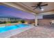 A beautiful pool and spa combination under a covered patio, ideal for relaxation and entertaining at 2153 Havensight Ln, Henderson, NV 89052