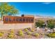 Community sign featuring modern design, desert landscaping, and mountain views at 2153 Havensight Ln, Henderson, NV 89052