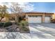 Charming single-story home features a tile roof, desert landscaping, and a three-car garage at 2329 Quartz Peak St, Las Vegas, NV 89134