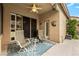 Covered patio with two chairs, a table, and a ceiling fan at 2329 Quartz Peak St, Las Vegas, NV 89134