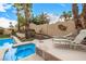 Backyard featuring a pool, spa, and seating area with lounge chairs at 2329 Quartz Peak St, Las Vegas, NV 89134