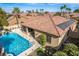 Aerial view of a private pool and patio area, surrounded by desert landscaping and a red tile roof house at 2329 Quartz Peak St, Las Vegas, NV 89134