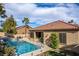 Inviting backyard pool with a waterfall feature and well-maintained landscaping, perfect for outdoor relaxation and entertainment at 2329 Quartz Peak St, Las Vegas, NV 89134