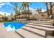 Backyard featuring a pool, spa, and steps leading to a seating area at 2329 Quartz Peak St, Las Vegas, NV 89134