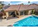 Backyard view of the pool, patio and red tile roof house with outdoor grill and seating area at 2329 Quartz Peak St, Las Vegas, NV 89134