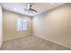 This bedroom has a ceiling fan and a bright window with white shutters at 2554 Corvus St, Henderson, NV 89044