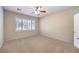 Bedroom featuring carpeted floors, a ceiling fan, a window with light-filtering shutters, and natural light at 2554 Corvus St, Henderson, NV 89044