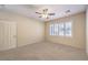 Bedroom showcasing carpeted floors, natural light, a ceiling fan, and a window with light-filtering shutters at 2554 Corvus St, Henderson, NV 89044