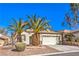 Charming single-story home featuring a two-car garage, desert landscaping, and mature palm trees in front at 2554 Corvus St, Henderson, NV 89044