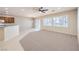 Open living room featuring carpet, a ceiling fan, and multiple windows with light-filtering shutters at 2554 Corvus St, Henderson, NV 89044