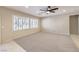 Bright, carpeted living area with modern ceiling fan, plantation shutters, and recessed lighting at 2554 Corvus St, Henderson, NV 89044