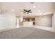 Open living room showcasing a ceiling fan, neutral walls, and direct access to the kitchen at 2554 Corvus St, Henderson, NV 89044