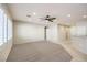 Bright, carpeted living area with modern ceiling fan, plantation shutters, and recessed lighting at 2554 Corvus St, Henderson, NV 89044