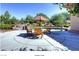 Outdoor patio with an umbrella, seating, decorative plants, and clear blue skies at 2554 Corvus St, Henderson, NV 89044