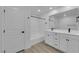 Bright bathroom with double vanity, white cabinets, and shower over tub at 2607 Aversa St, Henderson, NV 89044