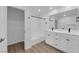 Modern bathroom featuring double sinks, a bathtub, and a separate toilet room at 2607 Aversa St, Henderson, NV 89044