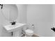 A bathroom featuring a pedestal sink and modern toilet at 2607 Aversa St, Henderson, NV 89044