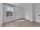 Well-lit bedroom featuring wood-look floors and large window at 2607 Aversa St, Henderson, NV 89044