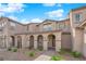 Beautiful townhome with a covered walkway, manicured shrubs, and desert landscaping at 2607 Aversa St, Henderson, NV 89044