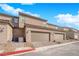 Rear of townhome showcasing two-car garages and exterior AC units at 2607 Aversa St, Henderson, NV 89044