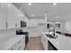 Contemporary kitchen with white cabinets, stainless steel appliances, and island with a black faucet at 2607 Aversa St, Henderson, NV 89044