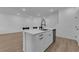 Bright kitchen featuring a white island with barstool seating and stainless steel dishwasher at 2607 Aversa St, Henderson, NV 89044