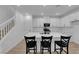 Stylish kitchen featuring white cabinets, island with bar stools, and stainless steel appliances at 2607 Aversa St, Henderson, NV 89044