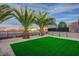 Backyard featuring desert landscaping and synthetic grass at 2820 Thunder Bay Ave, Henderson, NV 89052