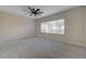 A spacious, carpeted bedroom with a ceiling fan and natural light from the window at 2820 Thunder Bay Ave, Henderson, NV 89052