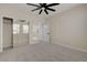 View of a neutral carpeted bedroom featuring a closet with mirrored doors and a ceiling fan at 2820 Thunder Bay Ave, Henderson, NV 89052