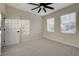 Neutral bedroom featuring carpeted floors, a ceiling fan, and dual windows for natural light at 2820 Thunder Bay Ave, Henderson, NV 89052