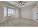 A bright bedroom featuring light wood floors, bay windows, and a ceiling fan at 2820 Thunder Bay Ave, Henderson, NV 89052