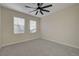 A bright, carpeted bedroom with a ceiling fan and natural light at 2820 Thunder Bay Ave, Henderson, NV 89052