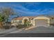 Inviting single-story home with desert landscaping and attached two-car garage provides ample parking and curb appeal at 2820 Thunder Bay Ave, Henderson, NV 89052