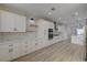 Spacious kitchen with white cabinets, stone backsplash, stainless appliances, and wood floors at 2820 Thunder Bay Ave, Henderson, NV 89052