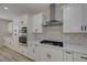 Modern kitchen featuring white cabinetry, a stone backsplash, and stainless steel appliances at 2820 Thunder Bay Ave, Henderson, NV 89052