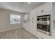 Well-lit kitchen featuring white cabinets, stone backsplash, stainless appliances, and wood floors at 2820 Thunder Bay Ave, Henderson, NV 89052