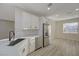 Modern kitchen featuring white cabinetry, a stone backsplash, and stainless steel refrigerator at 2820 Thunder Bay Ave, Henderson, NV 89052