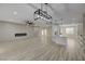 Open-concept living room with modern fireplace, ceiling fan, and adjacent kitchen at 2820 Thunder Bay Ave, Henderson, NV 89052