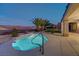 Beautiful pool with a rock waterfall feature surrounded by desert landscaping and a tall palm tree at 2820 Thunder Bay Ave, Henderson, NV 89052