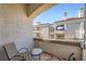 Private balcony offers a cozy seating area and views of the surrounding community at 3150 Soft Breezes Dr # 2022, Las Vegas, NV 89128