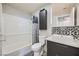 Modern bathroom featuring a stylish vanity with vessel sink and decorative tile backsplash at 3150 Soft Breezes Dr # 2022, Las Vegas, NV 89128