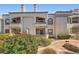 Condo building exterior featuring stucco facade, red tile roof and private balcony at 3150 Soft Breezes Dr # 2022, Las Vegas, NV 89128