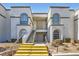 Exterior view of building with arched windows, tan stucco and yellow painted stairs at 3150 Soft Breezes Dr # 2022, Las Vegas, NV 89128