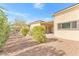 View of desert landscaping and covered patio area in the backyard at 379 Turquoise Ct, Boulder City, NV 89005