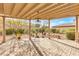 View of the large brick-paved covered patio with view of desert landscaping at 379 Turquoise Ct, Boulder City, NV 89005