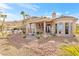 Back of house shows outdoor living space and desert landscaping with mountain views in the distance at 379 Turquoise Ct, Boulder City, NV 89005