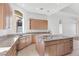 Well-equipped kitchen with wooden cabinetry, granite countertops, and stainless steel appliances at 379 Turquoise Ct, Boulder City, NV 89005