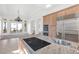 Modern kitchen with granite island, stainless appliances, and chandelier at 379 Turquoise Ct, Boulder City, NV 89005