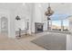 Spacious living room with fireplace, large windows with mountain views, and elegant chandeliers at 379 Turquoise Ct, Boulder City, NV 89005